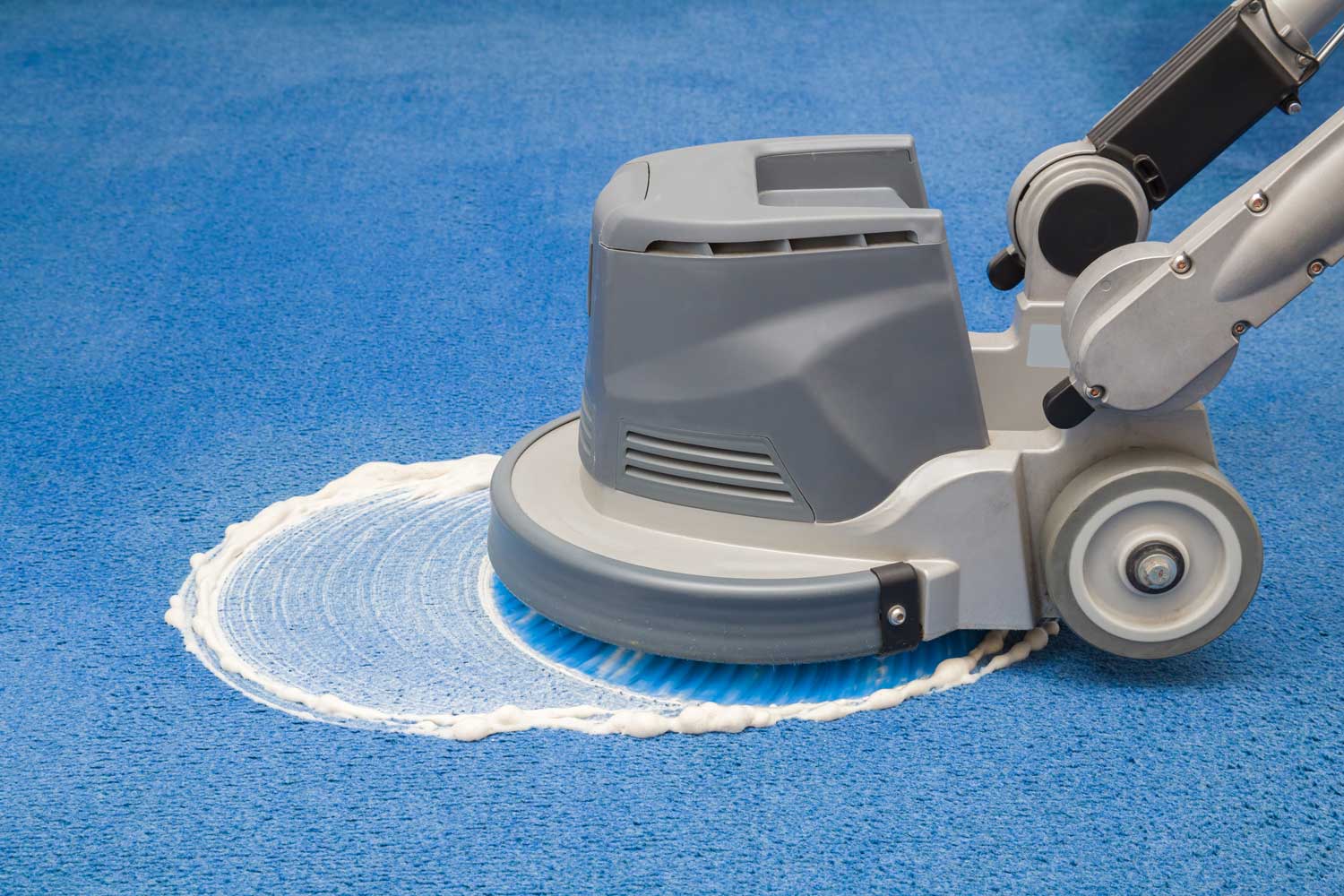 Commercial carpet cleaning machine extracting an office carpet