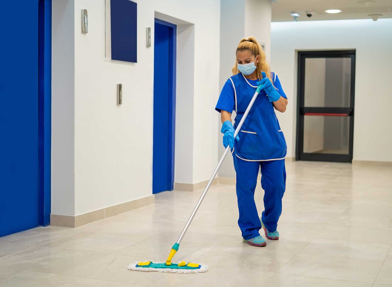 Professional cleaner servicing a commercial office interior