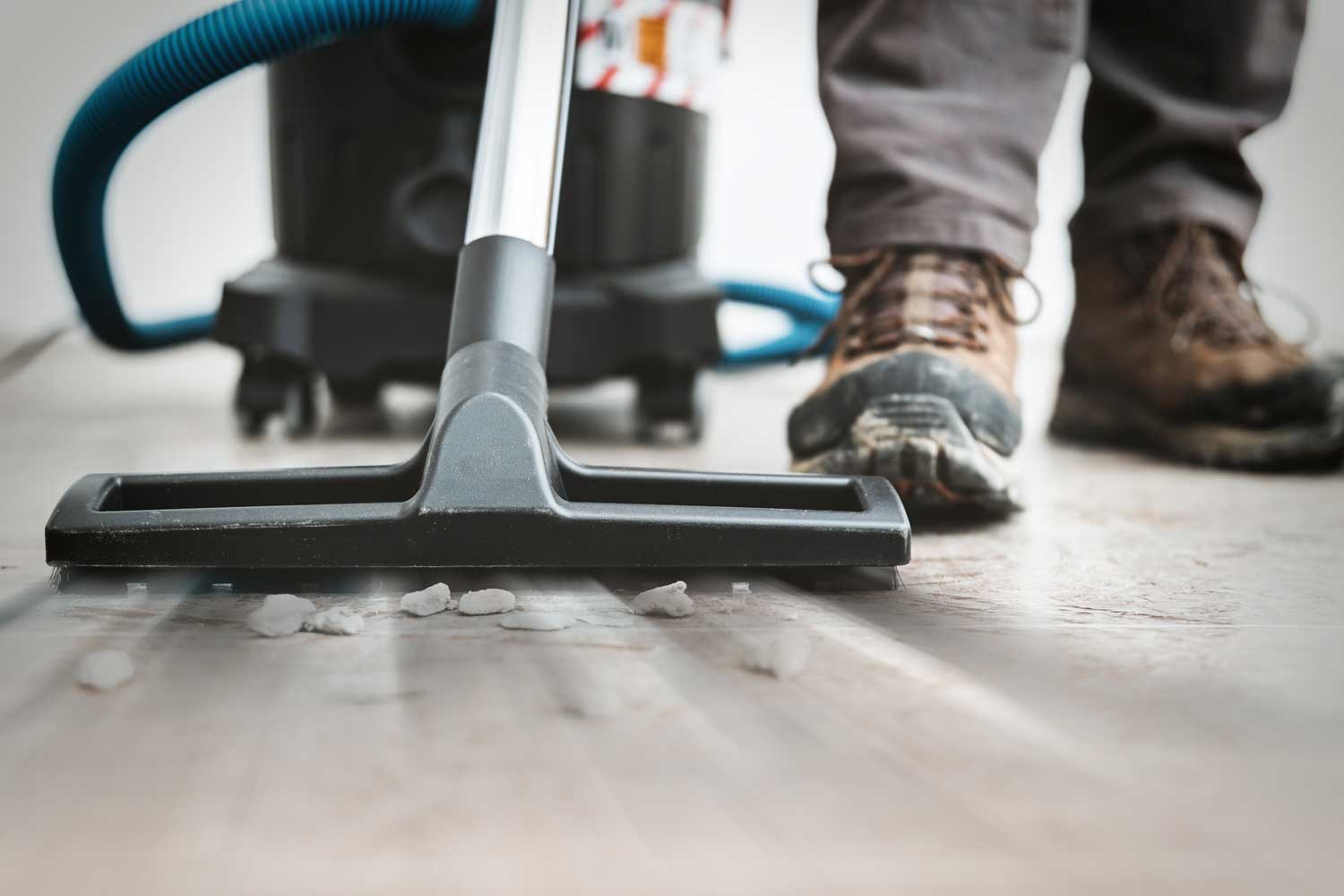 Industrial vacuum removing construction dust from a new-build floor