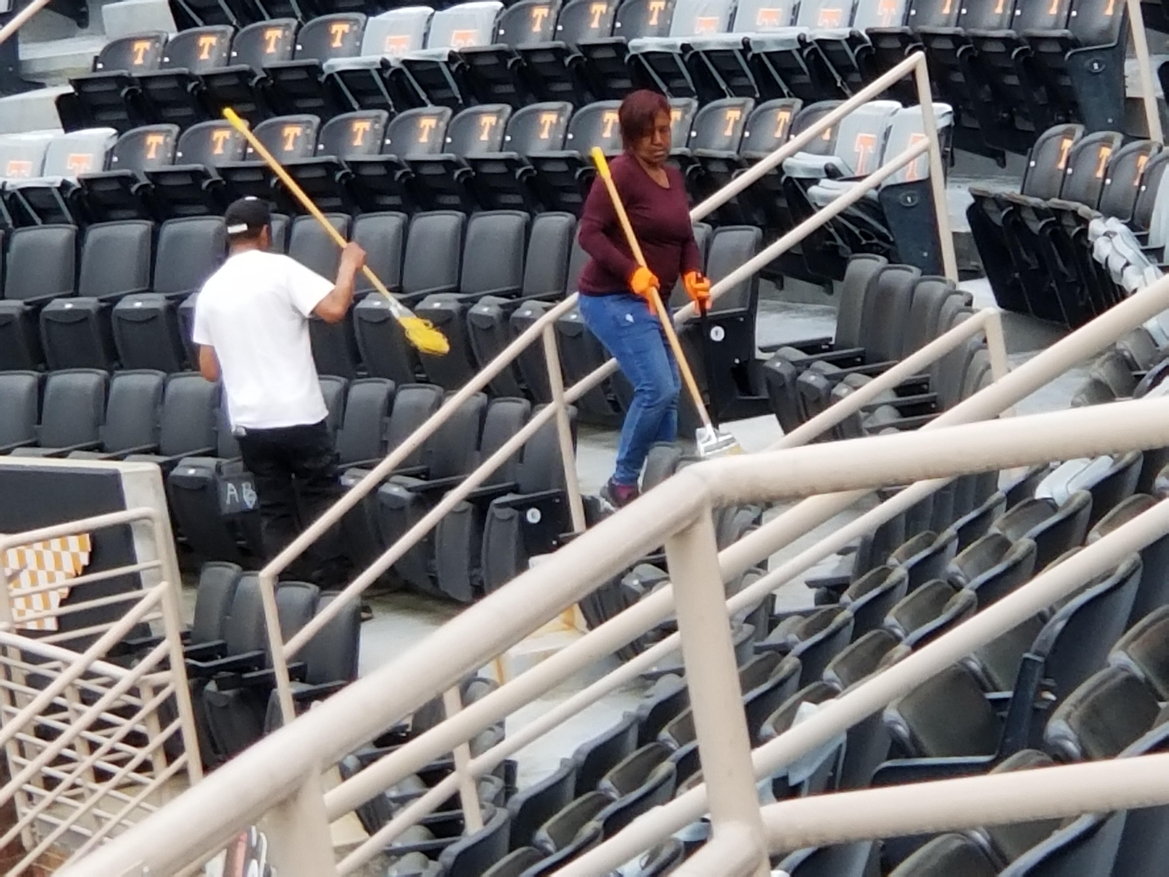 National Building Service crew sweeping between stadium seating rows in Knoxville